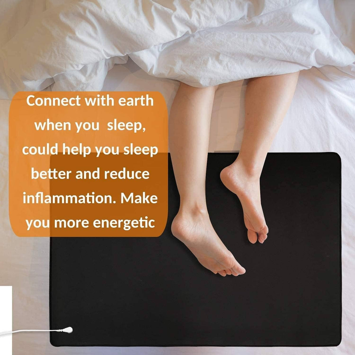 Black grounding mat for sleeping, feet placed on smooth surface