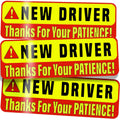 Close-up of stacked “New Driver” magnetic signs with red warning border.