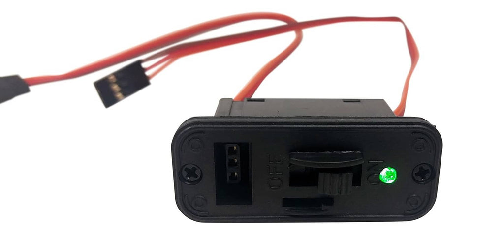 RC on/off switch module showing top housing with red/orange wire leads and plugs