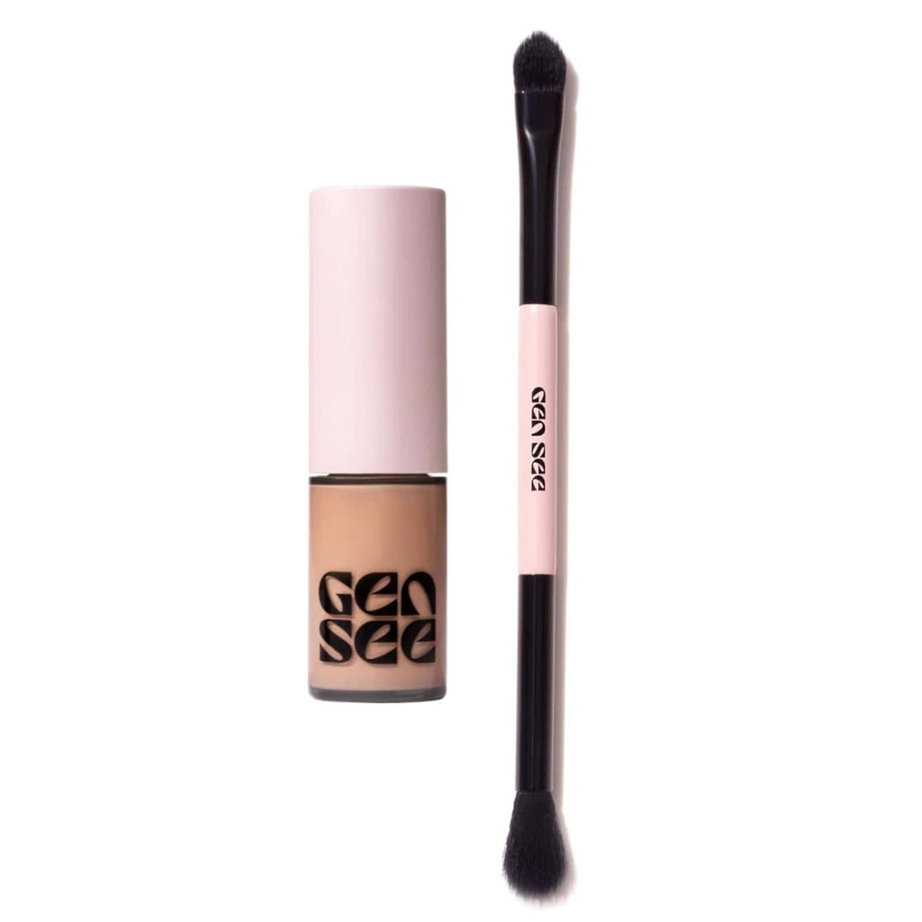 Rose-gold liquid eyeshadow tube with black-handled blending brush, pink cap