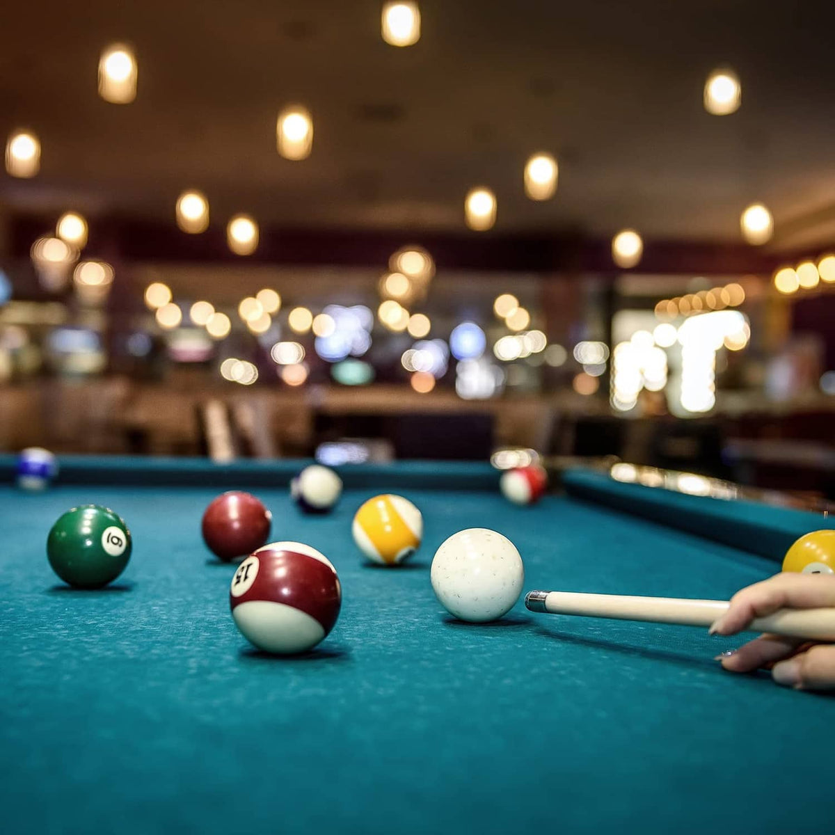 Black pool cue tip cover on the cue end