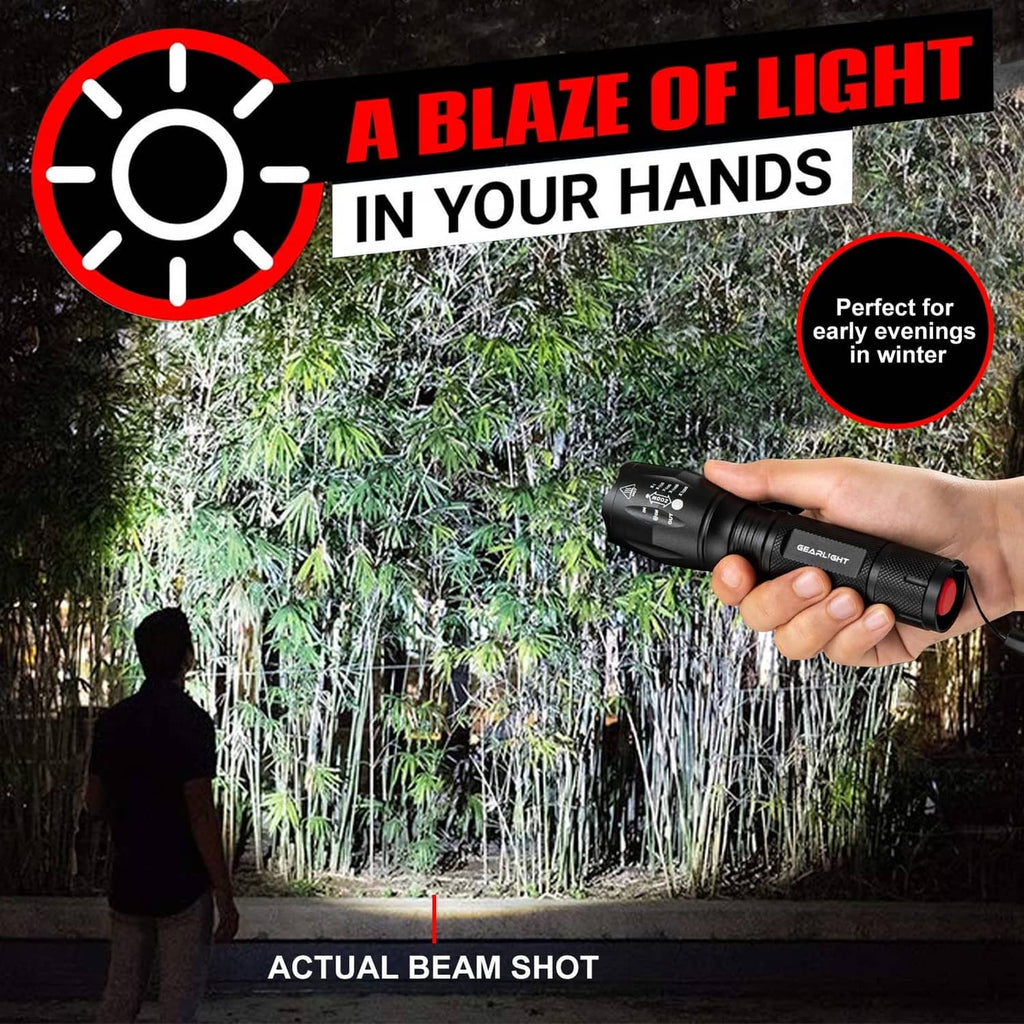 GearLight LED flashlight in hand, black body with wrist strap