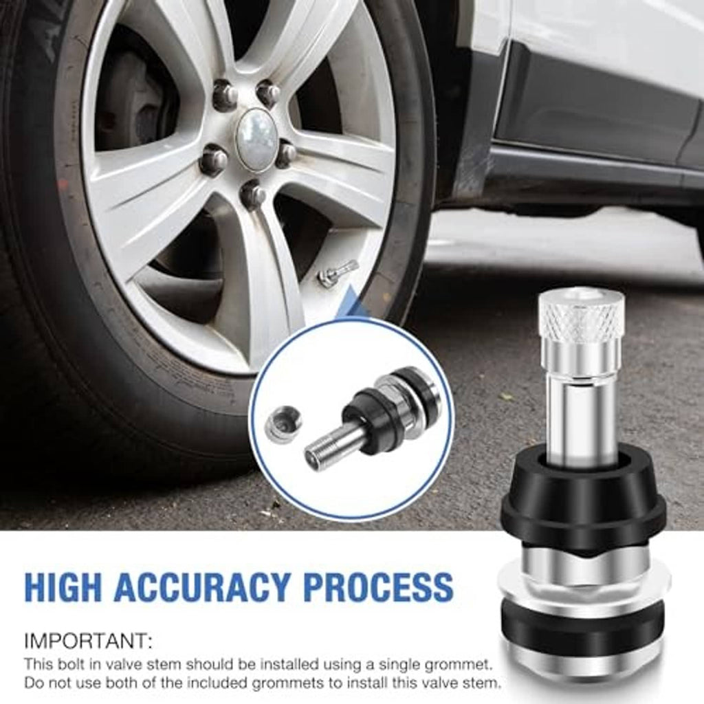 Clamp-in metal valve stem near a car wheel, showing black rubber seal and silver shaft