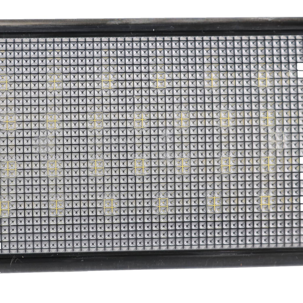 Close-up of LED lens surface with grid pattern and small light emitter points