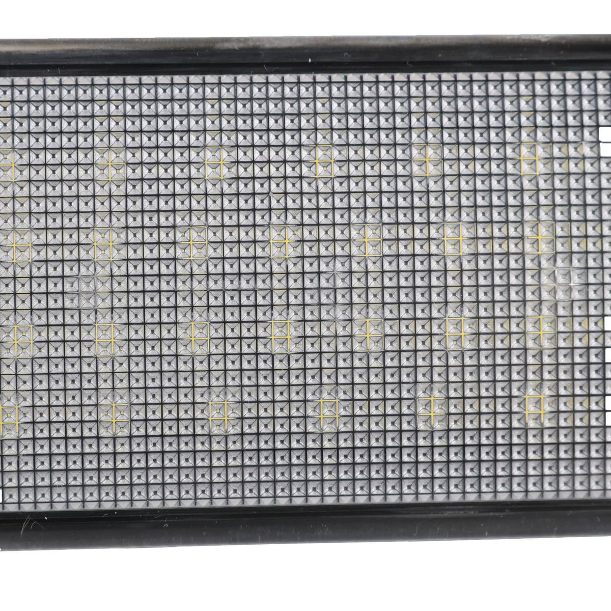 Close-up of LED lens surface with grid pattern and small light emitter points