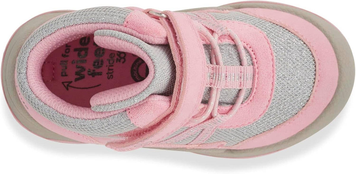Kids' high-top sneakers showing inner lining and lace-up with pink trim
