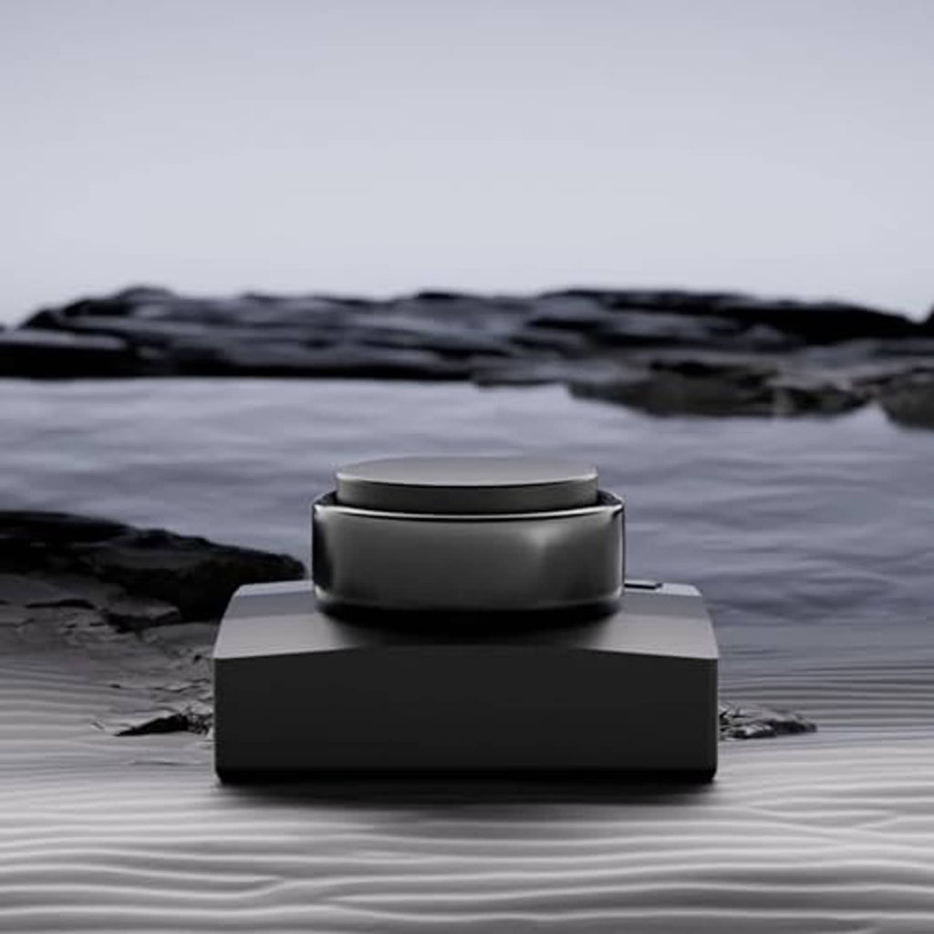Black ring charger dock with circular top placed on a textured surface