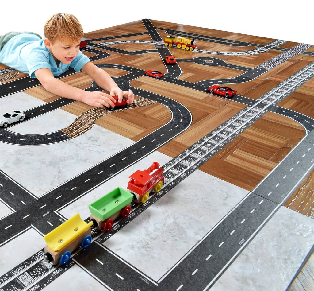 Toy road track tape layout with black asphalt roads and white lane lines, toy cars on top