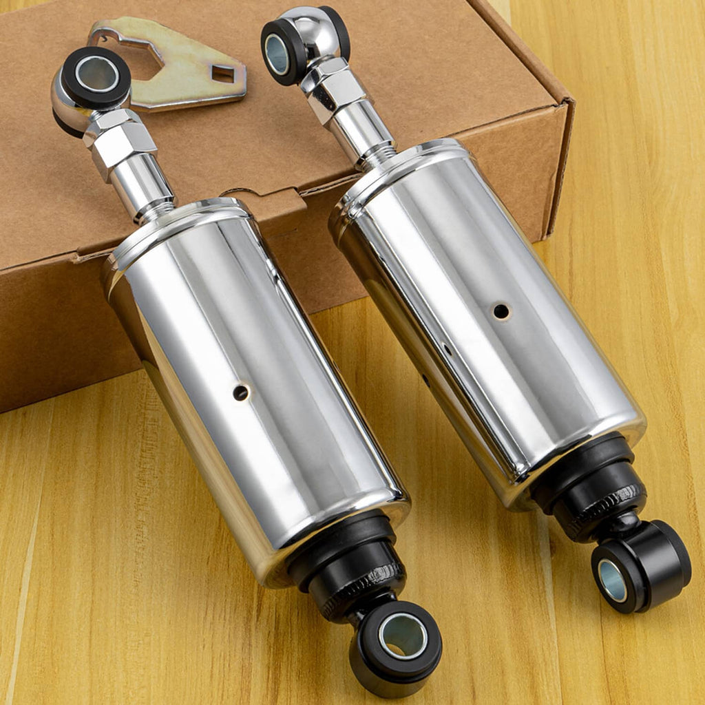 Two chrome rear shock absorbers with black rubber bushings and steel mounting plates