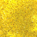 Banana-shaped yellow candy pieces, small curved bites in bulk