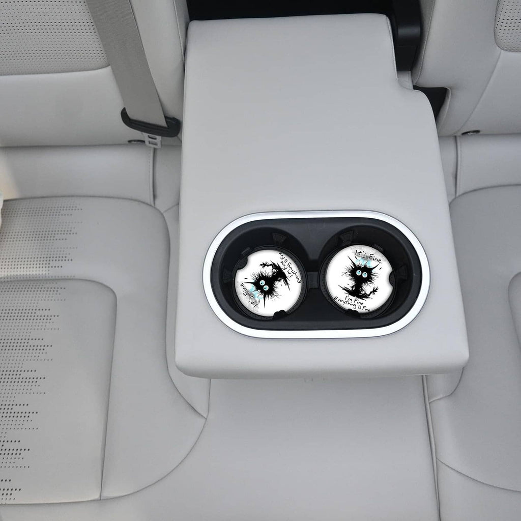 Pair of round car cupholders fitted with black cat ceramic coasters and cork trim
