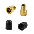 Brass Presta-to-Schrader bike valve adapter with black rubber dust cap, threaded ends