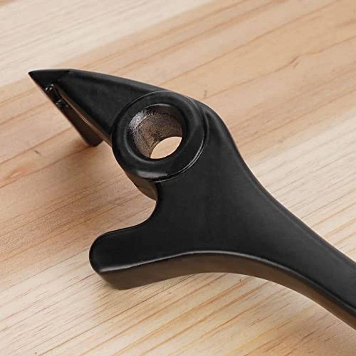 Black brake lever end with round mounting hole and curved hand grip