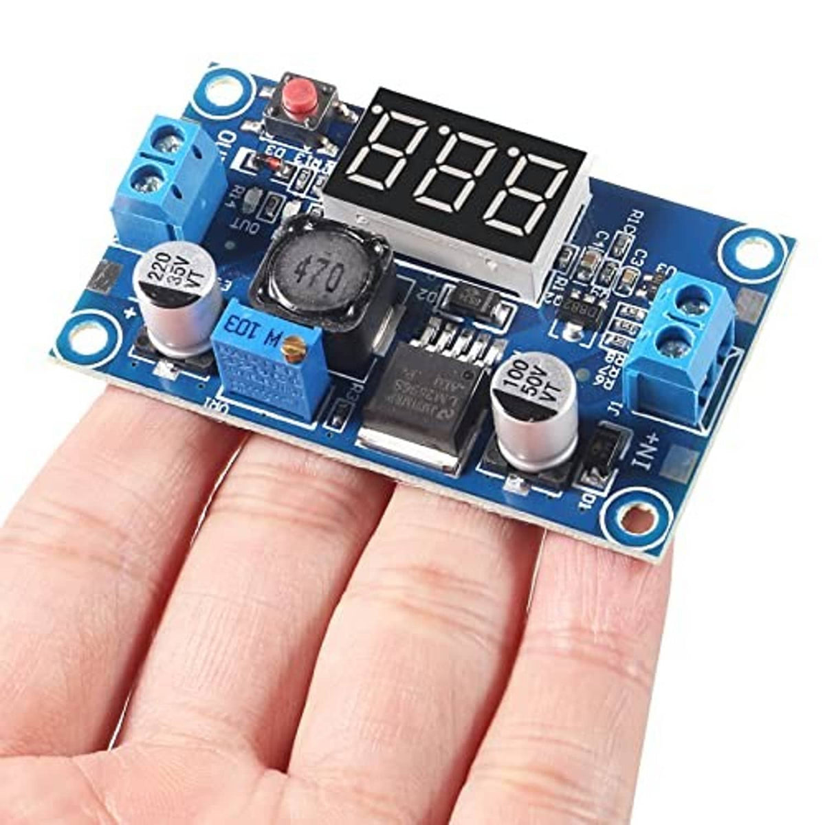 LM2596 buck converter module held in hand, showing four-digit LED voltage display and blue input terminals