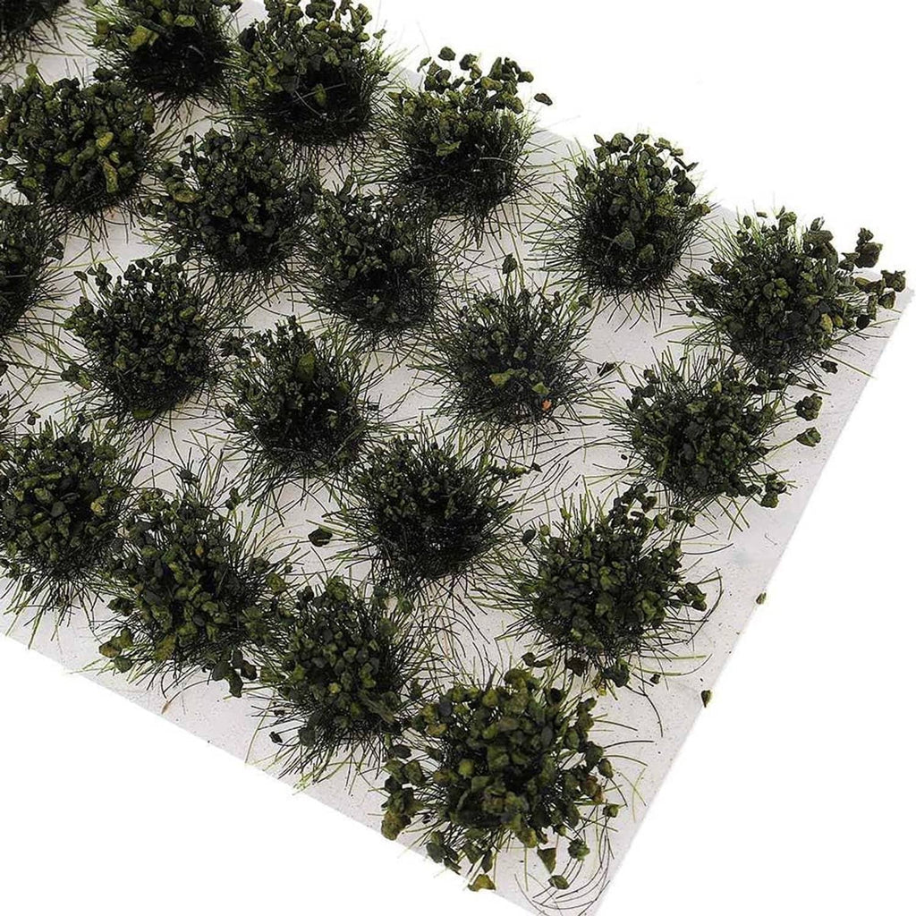 Green bushy shrub tuft bushes scattered on a white terrain backing sheet