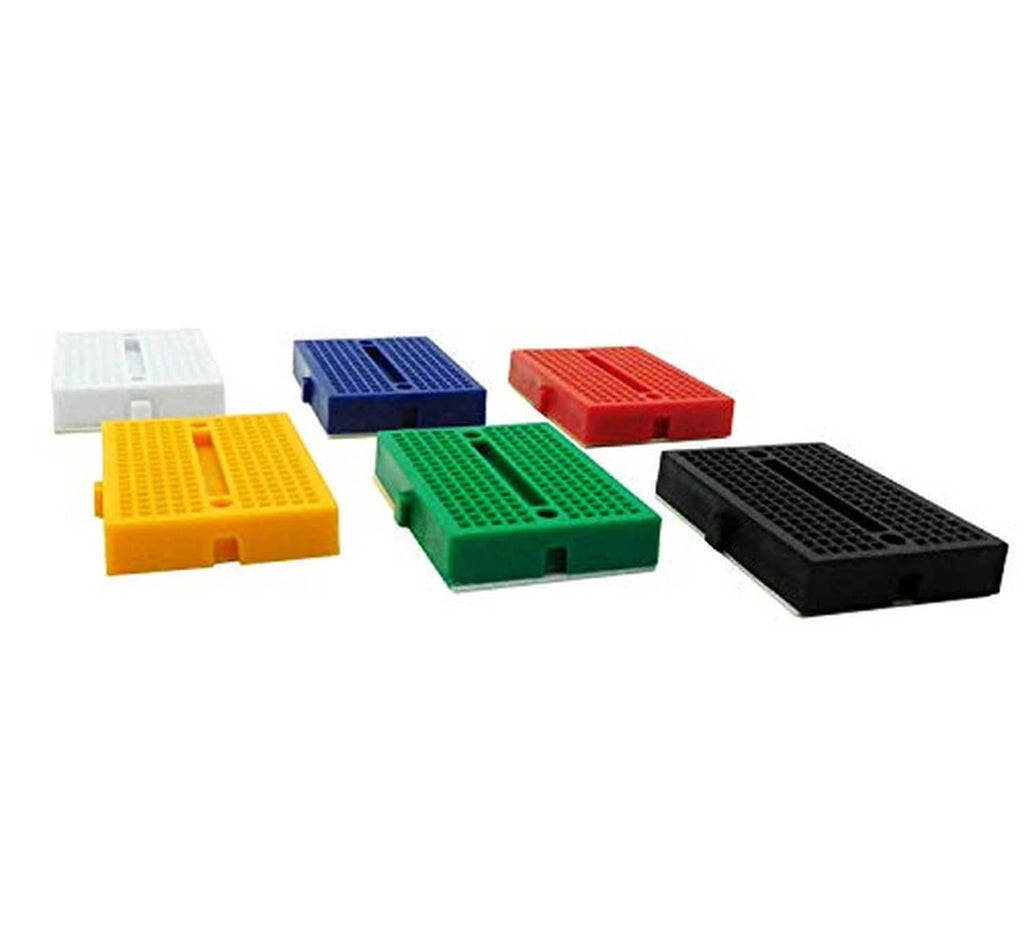 Colored mini solderless breadboards with pin grids, including yellow, green, black, and blue.