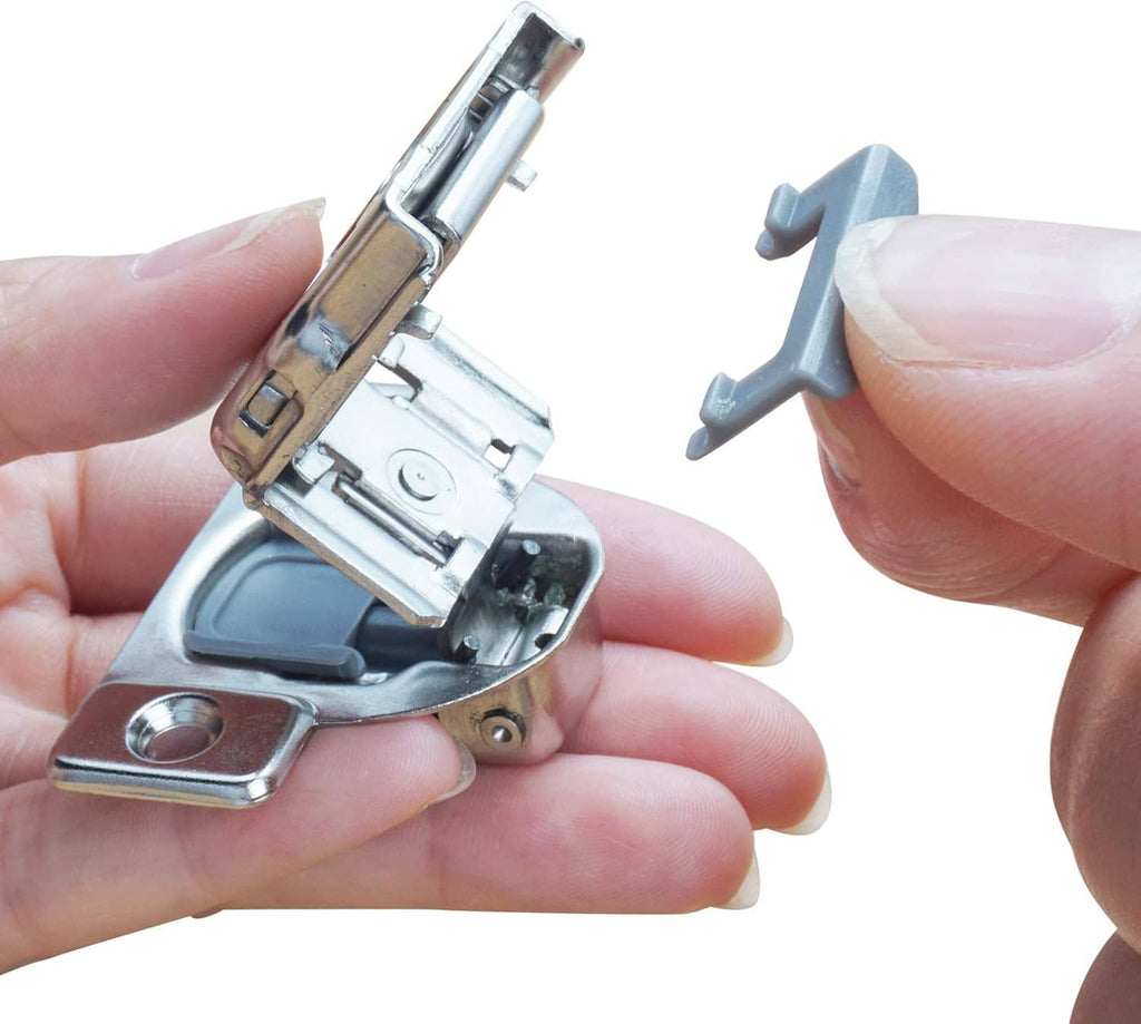 Metal hinge restriction clip with gray stop piece, held for size reference