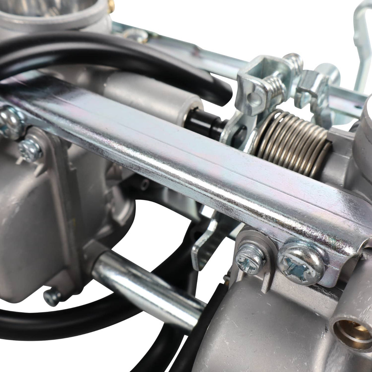 Carburetor linkage close-up with metal support bar and black hoses