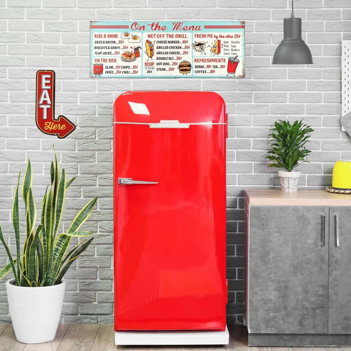 Metal diner menu sign with “On the Menu” header mounted above a red appliance