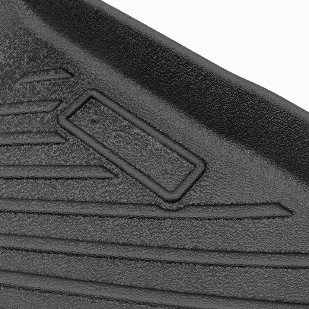 Black TPE floor mat with molded retention tab and textured traction pattern