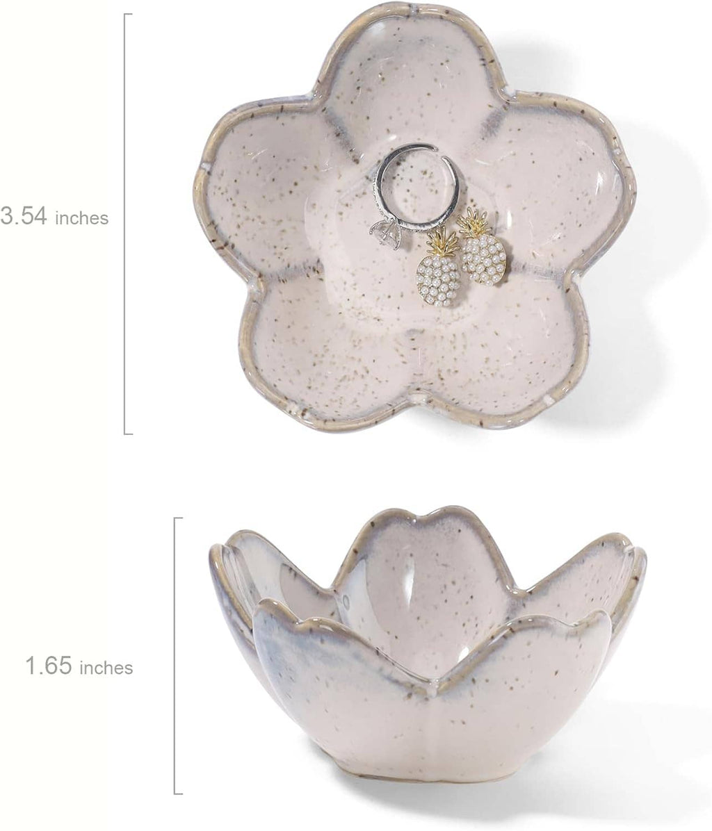 Speckled ceramic flower dish with two rings and a gold-and-pearl flower charm