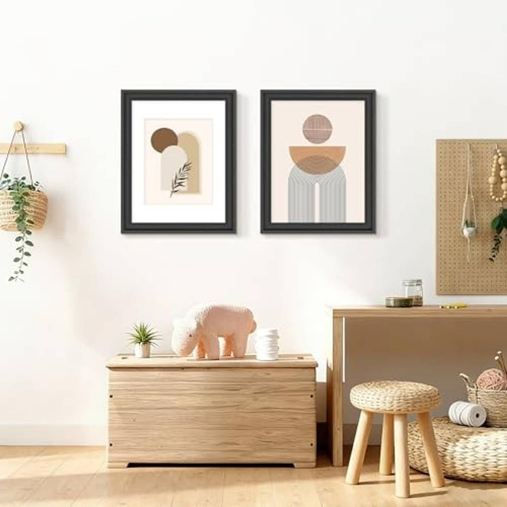 Black picture frames with white mats displayed on wall, shown in a home setting