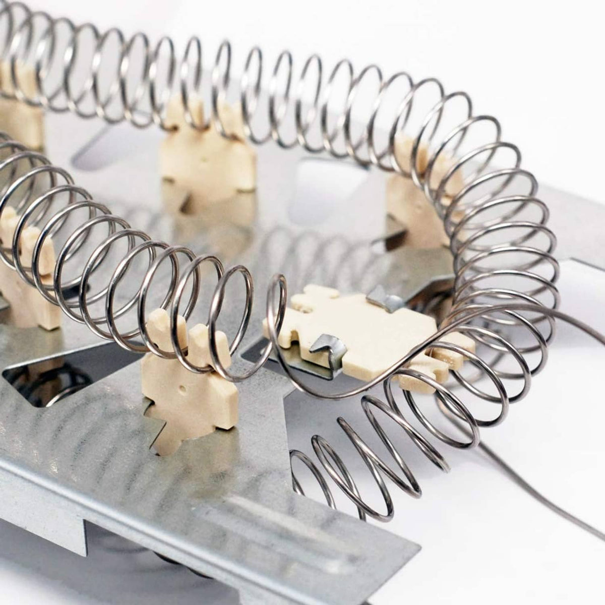 Dryer heating element coils with beige ceramic terminal blocks and attached wiring leads