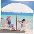 Cream patio umbrella with white fringe canopy and center wooden pole