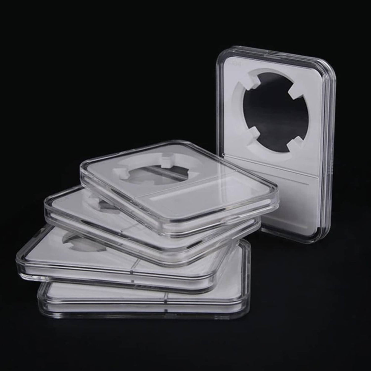 Stack of acrylic coin slab holders, clear cases with round coin openings
