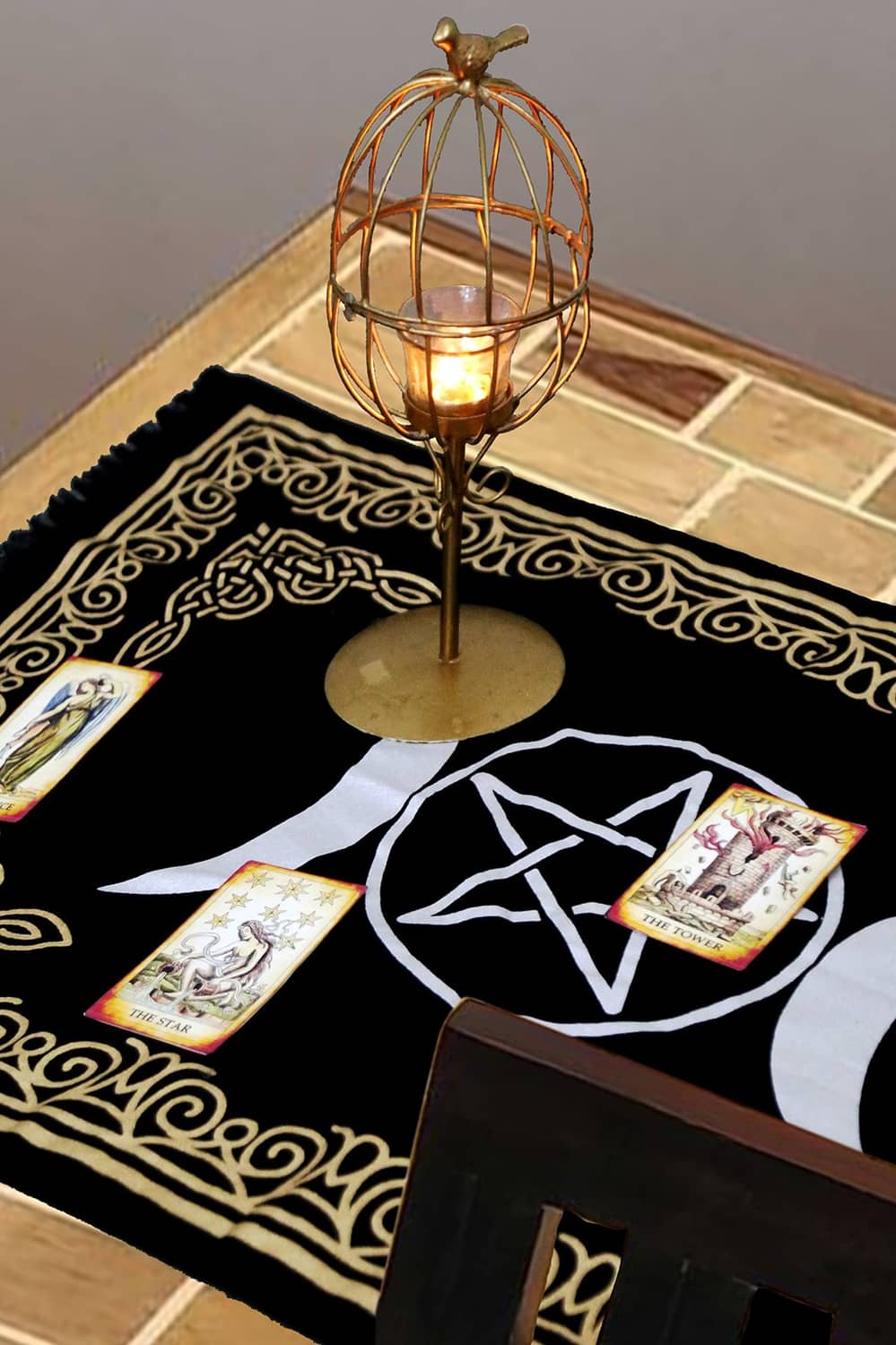 Black altar cloth with gold border, moon phases, pentagram motif, and cards