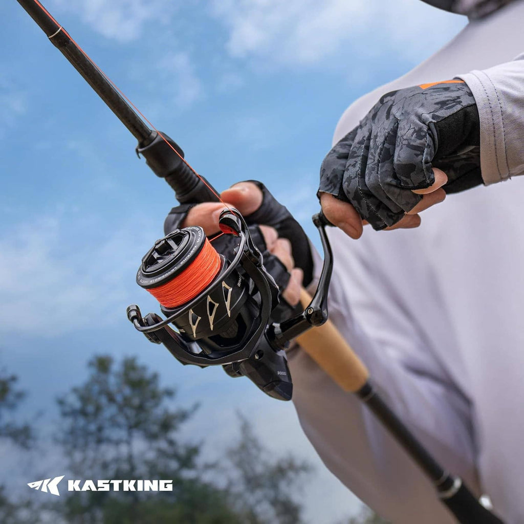 Spinning fishing reel attached to rod being held by a person outdoors
