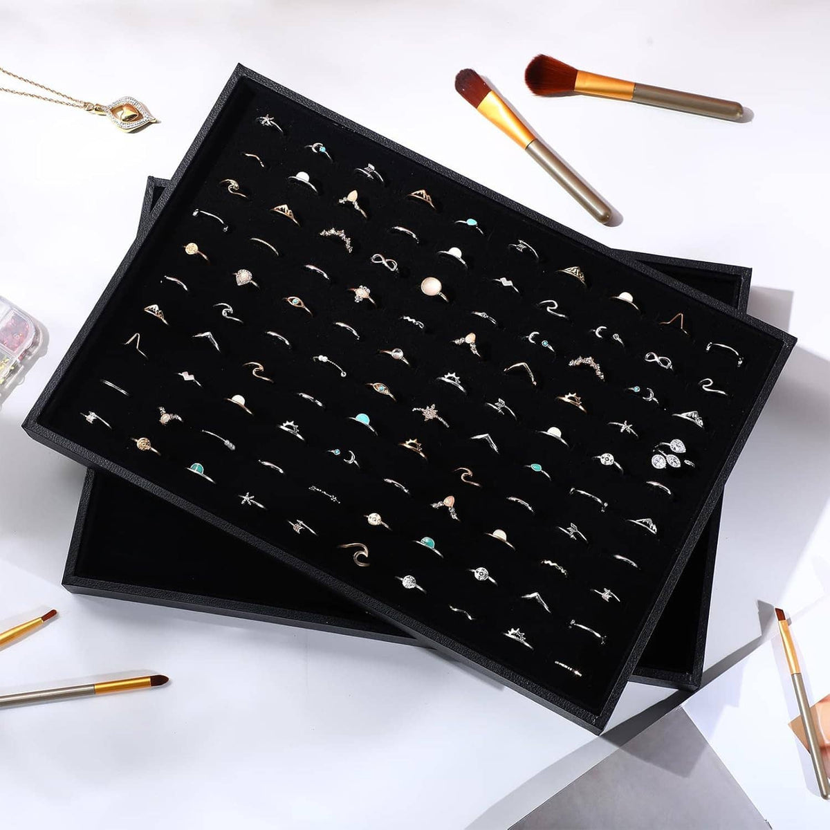 Open black ring holder tray with velvet inserts and 100 ring slots
