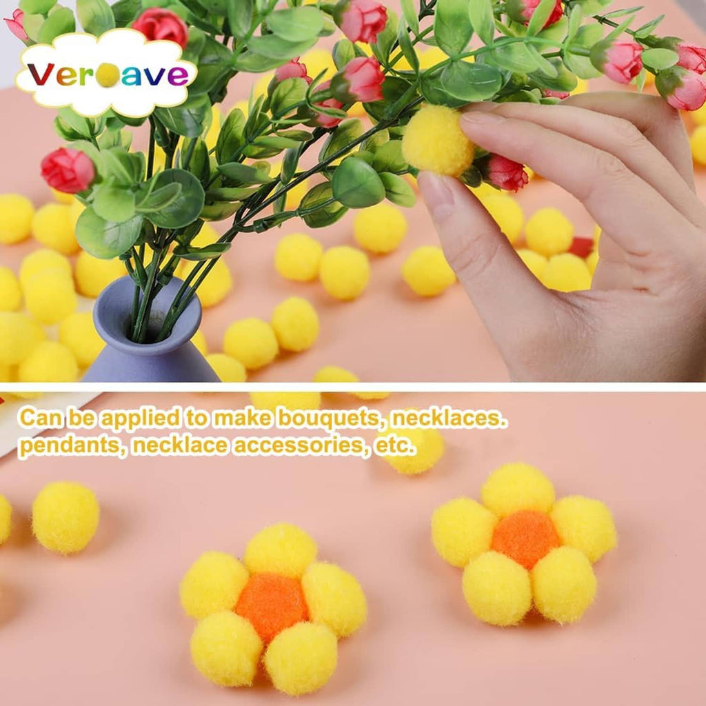 Yellow pom pom craft pieces on and around a bouquet arrangement