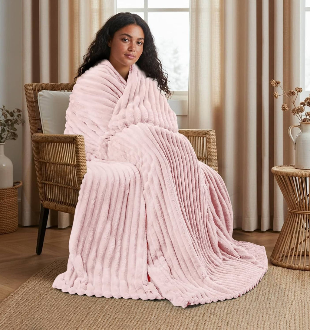 Pink striped fleece blanket wrapped around a woman, drape and ridges visible