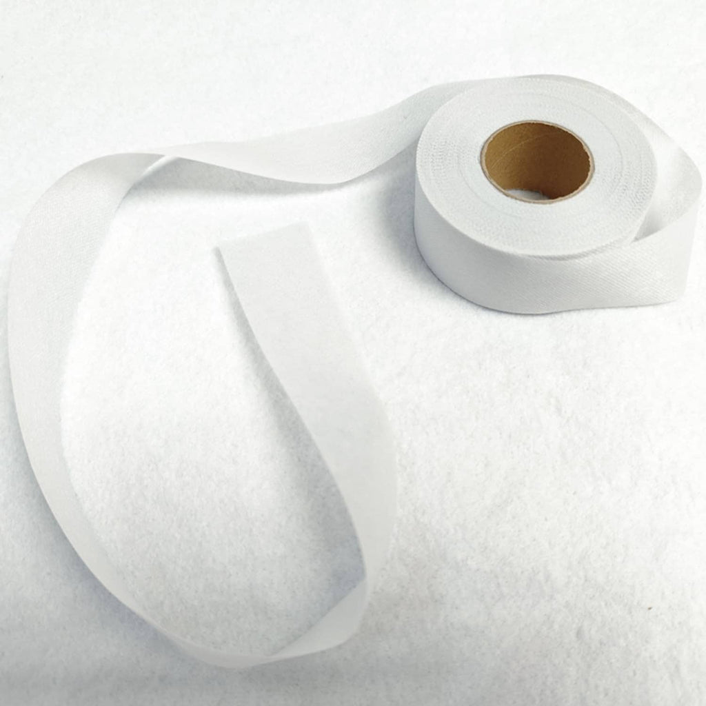 White fusible batting tape roll with another tape strip laid beside it