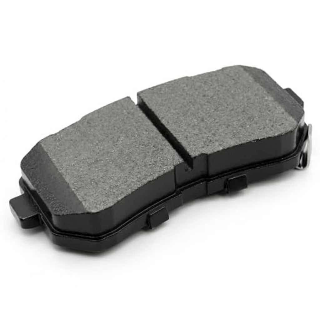 Angled view of gray ceramic brake pad with black backing and two-part friction surface