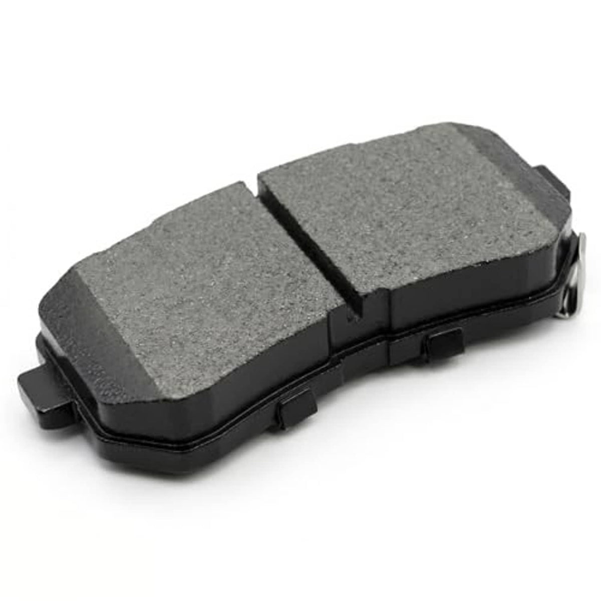 Angled view of gray ceramic brake pad with black backing and two-part friction surface