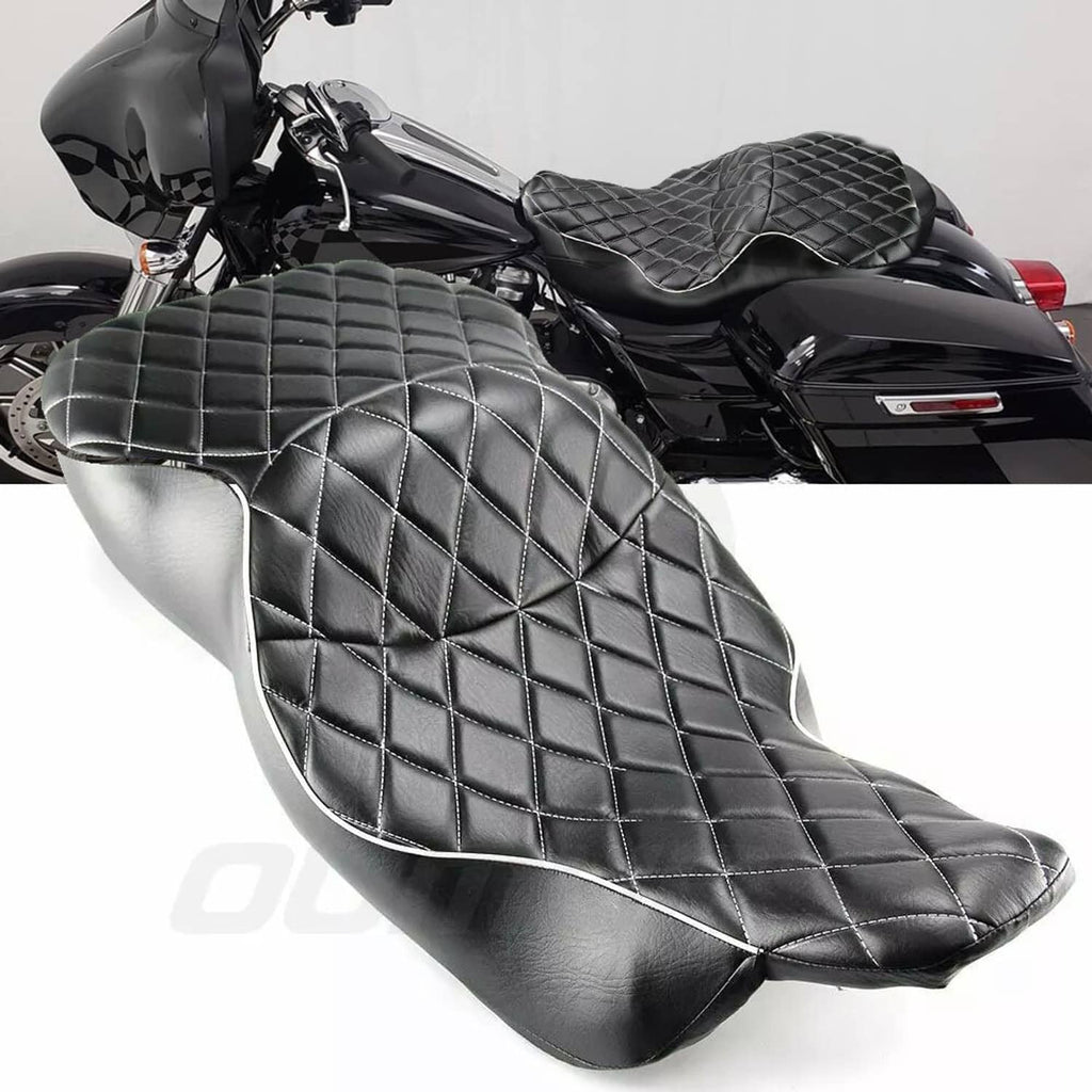 Black quilted motorcycle seat with diamond stitching and silver edge piping, angled view