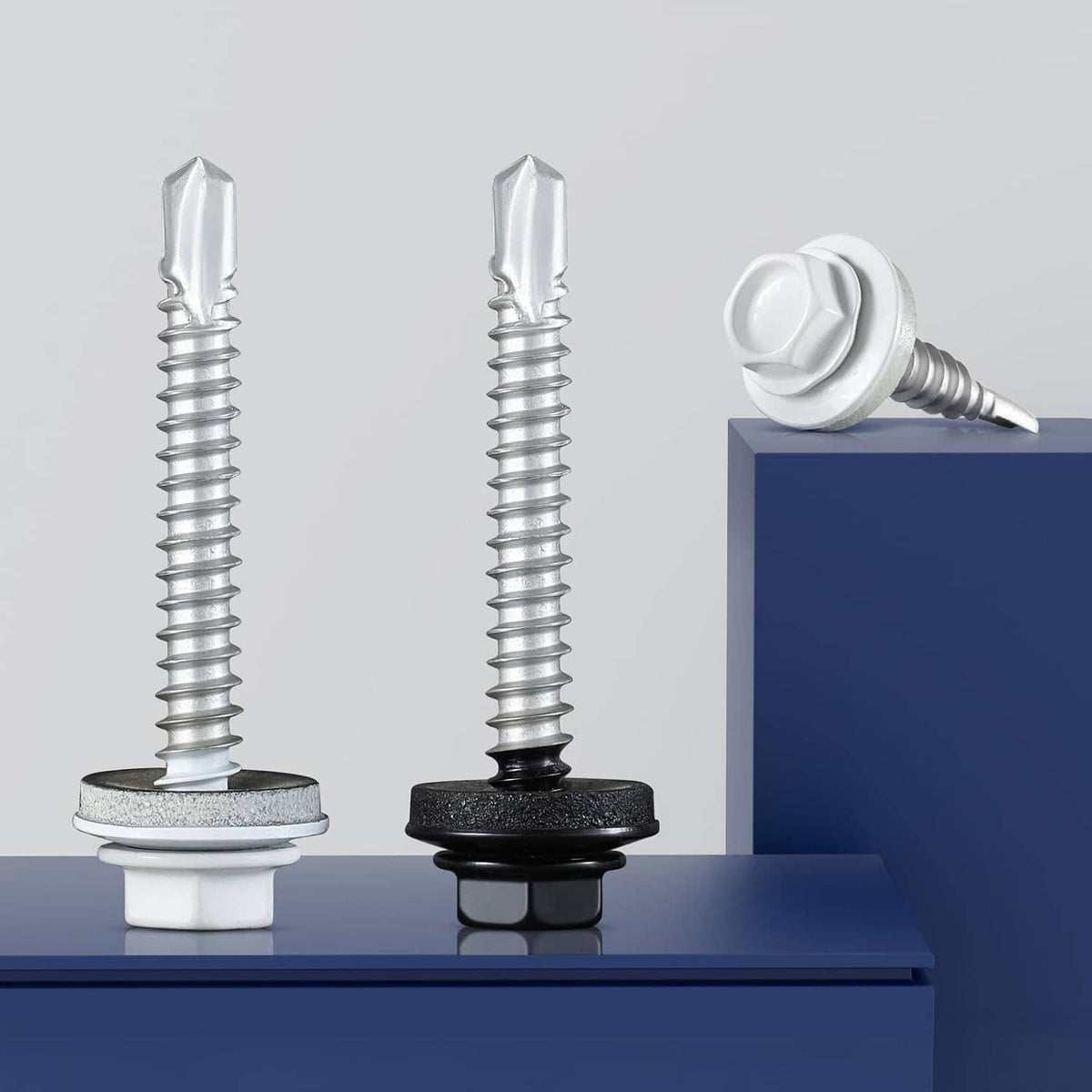 Metal roofing screws with EPDM washers: one white, one dark, standing on sheet edge