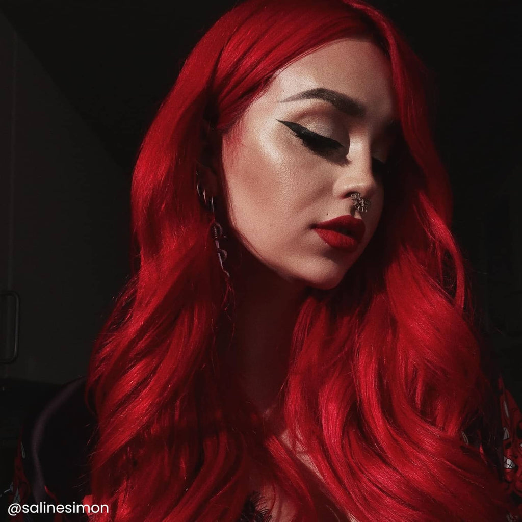 Woman with long vivid red hair, semi-permanent hair dye result, side profile