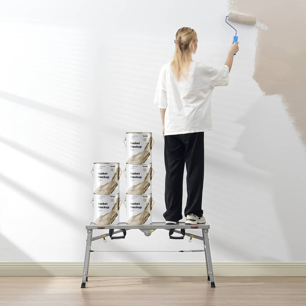 Portable adjustable scaffolding platform with person reaching to paint a wall from top