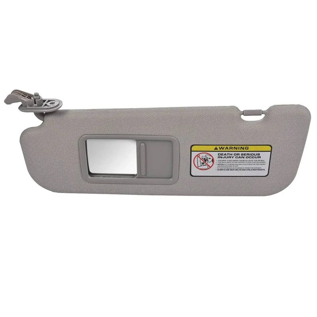 Grey left sun visor with rectangular vanity mirror window and warning label