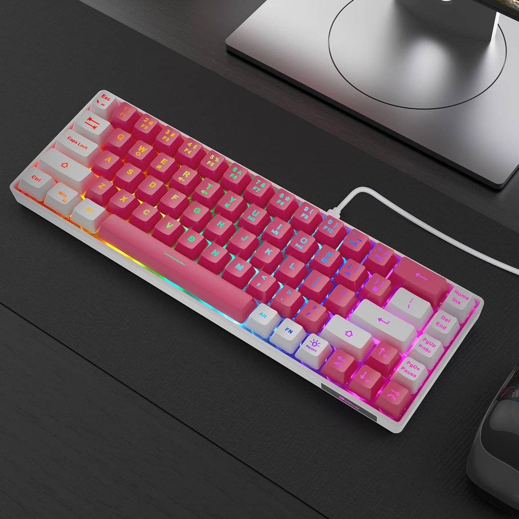 Pink-white RGB LED backlit mini wired keyboard on desktop, compact layout