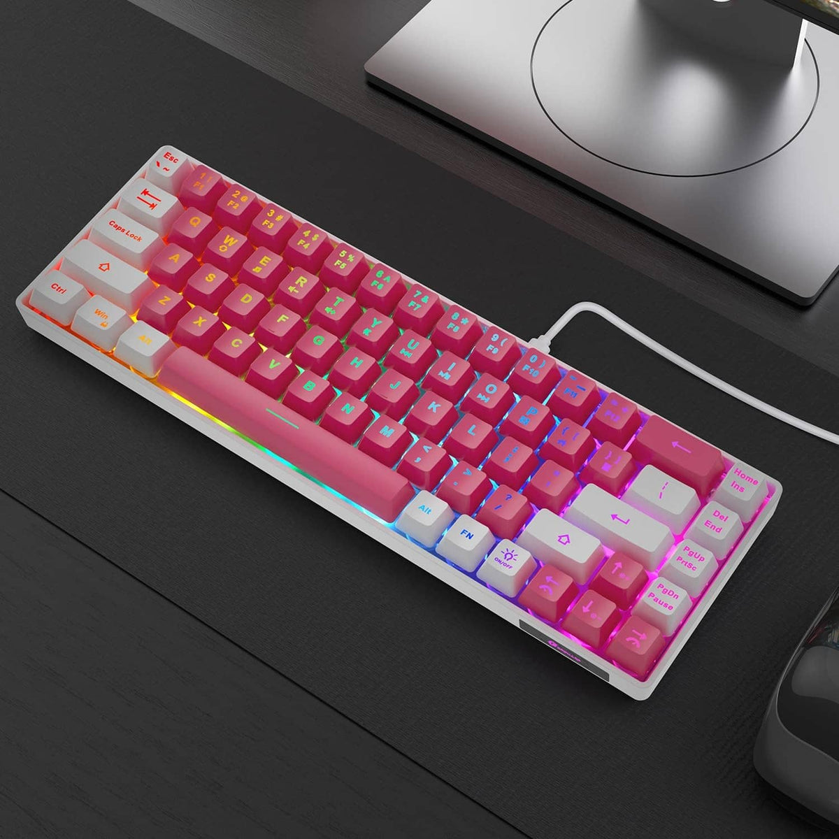 Pink-white RGB LED backlit mini wired keyboard on desktop, compact layout