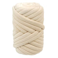Beige chunky arm-knitting yarn ball with thick braided loops.