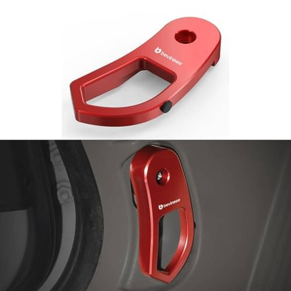 Red hood latch release lever handle bracket with oval cutout and black tip.