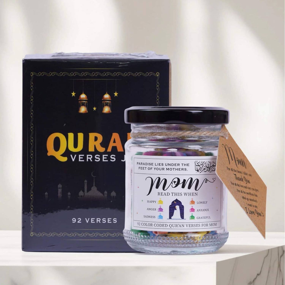 Quran verses jar with dark lid next to 92-verse gift box and Mom greeting card