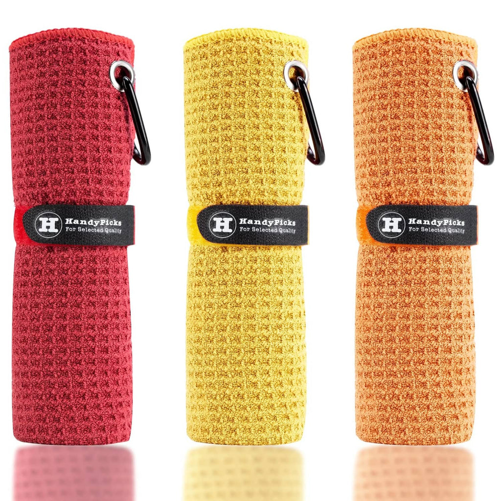 Microfiber golf towels, rolled red, yellow, and orange with hanging loop and clip