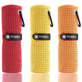 Microfiber golf towels, rolled red, yellow, and orange with hanging loop and clip