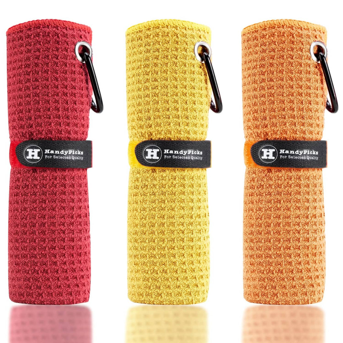 Microfiber golf towels, rolled red, yellow, and orange with hanging loop and clip